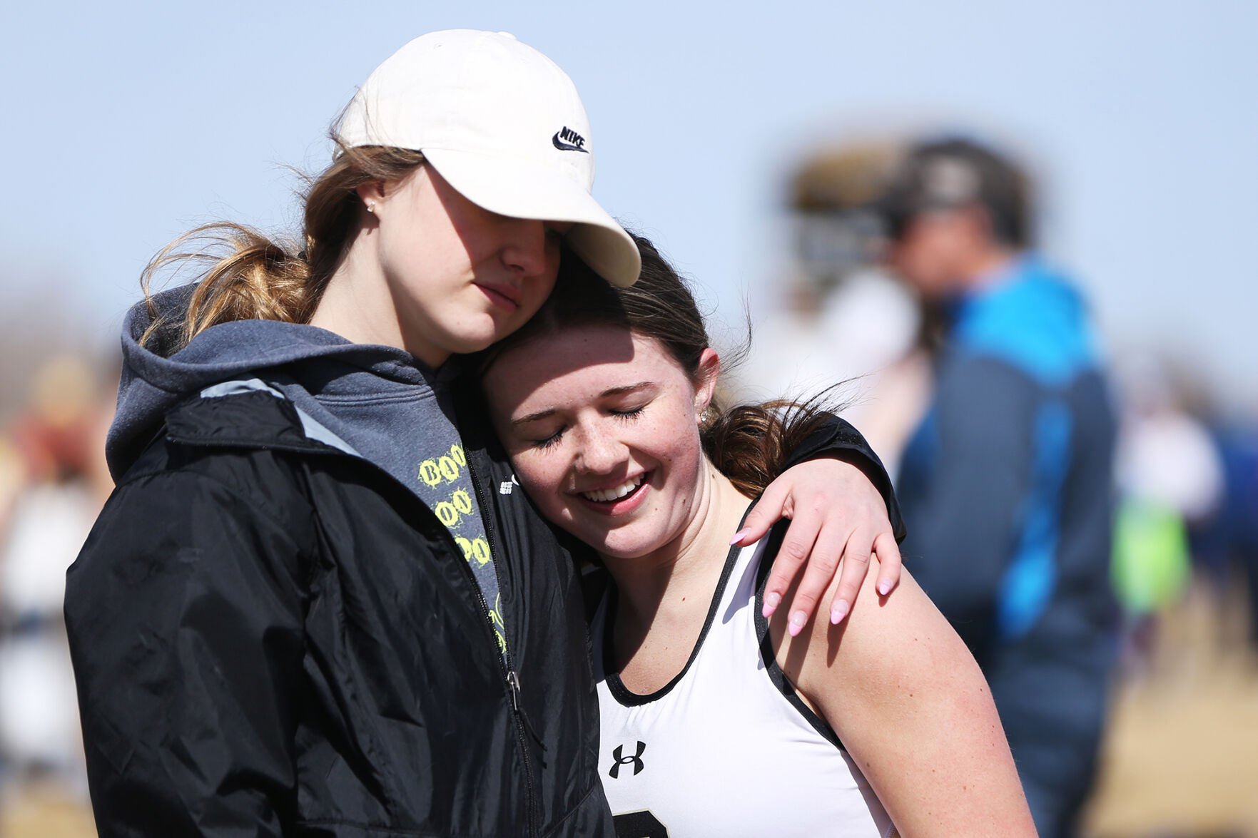 Caydence Engling hugs mile runner Kenley Jones after the end of her race